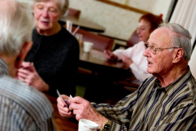 Group of old people playing cards