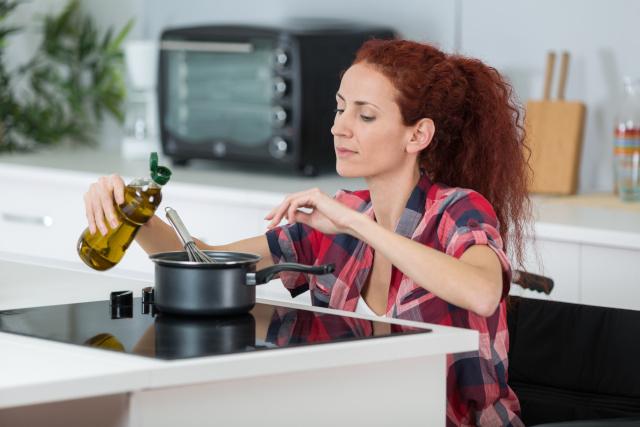 Woman in a wheelchair cooking