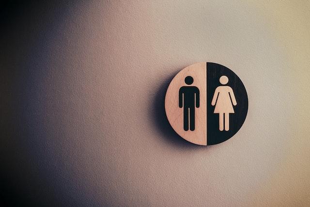 A black an white sign of a silhouette of a man and woman