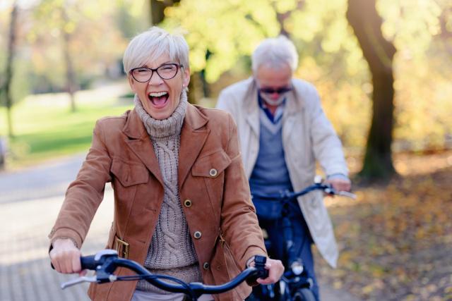 Two senior people riding bikes